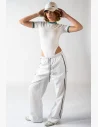 Light parachute pants in a premium Royal White finish with dark green and gold embroidery, adjustable draw at the waist and ankles for a confident and stylish look.